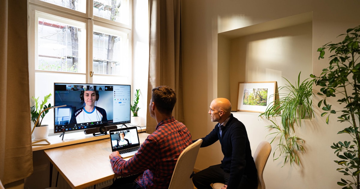 man in black long sleeve shirt sitting on chair in front of computer
