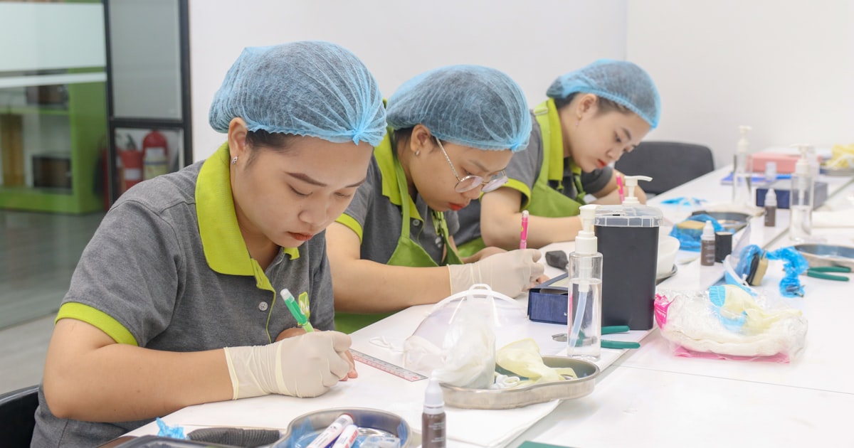A group of people sitting at a table working on something