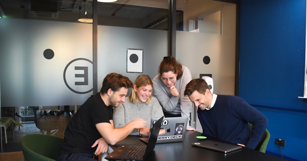 people sitting on chair in front of laptop computers