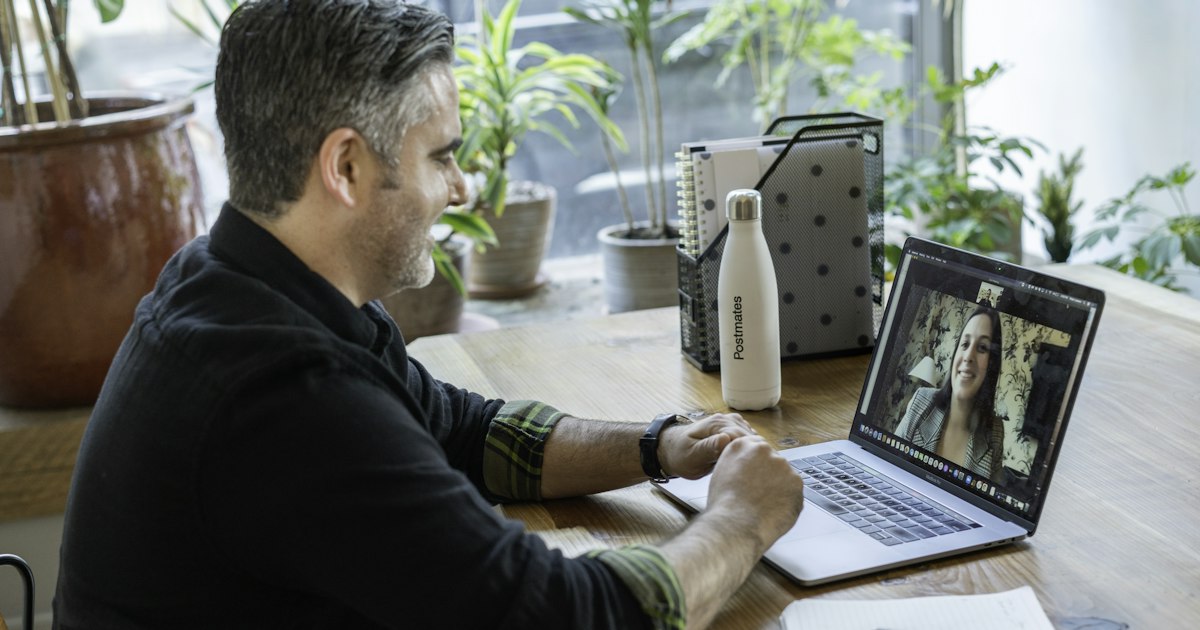 man in black sweater using macbook pro