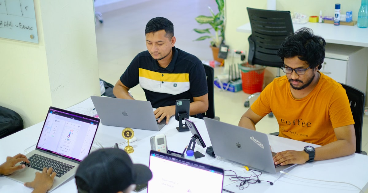 people sitting at the table using laptops