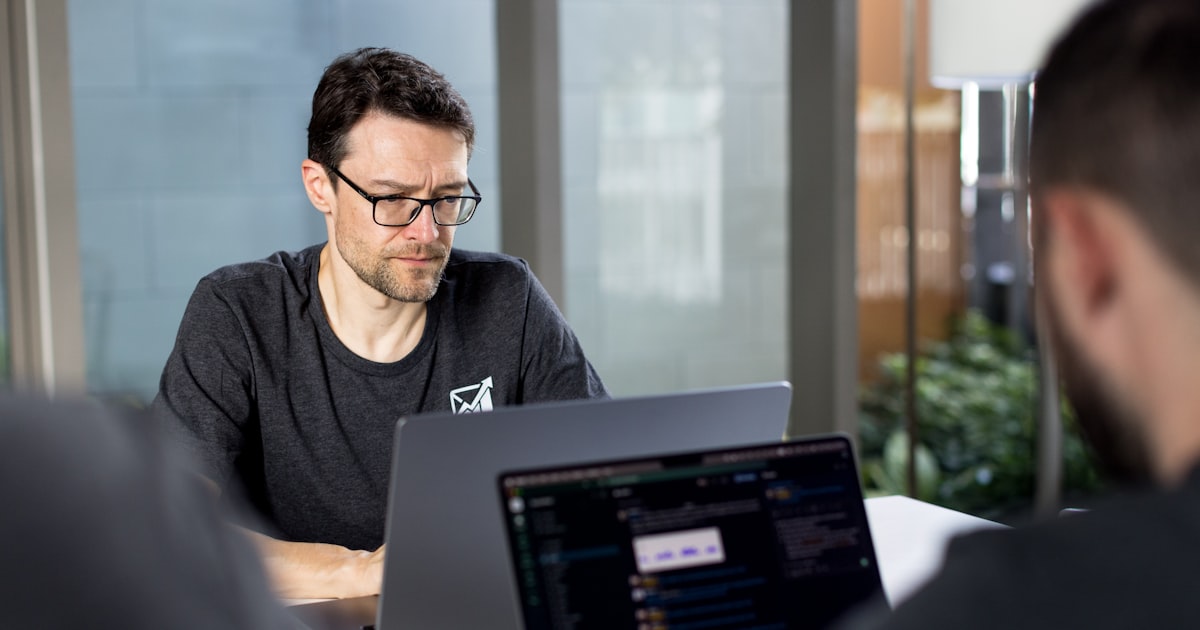 a man sitting in front of a laptop computer