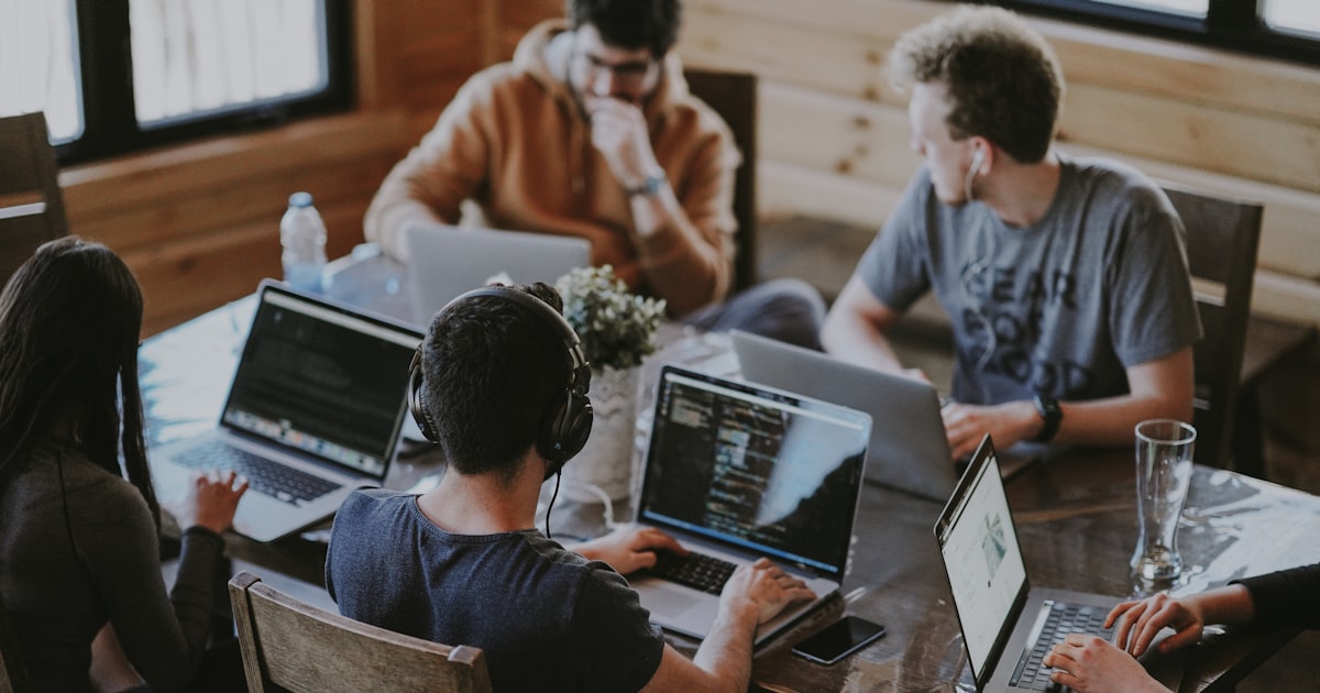 group of people using laptop computer