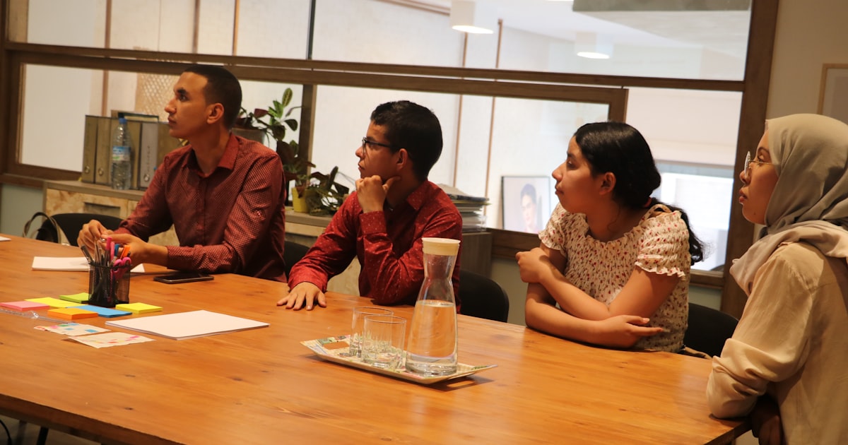 two women and men sitting at table